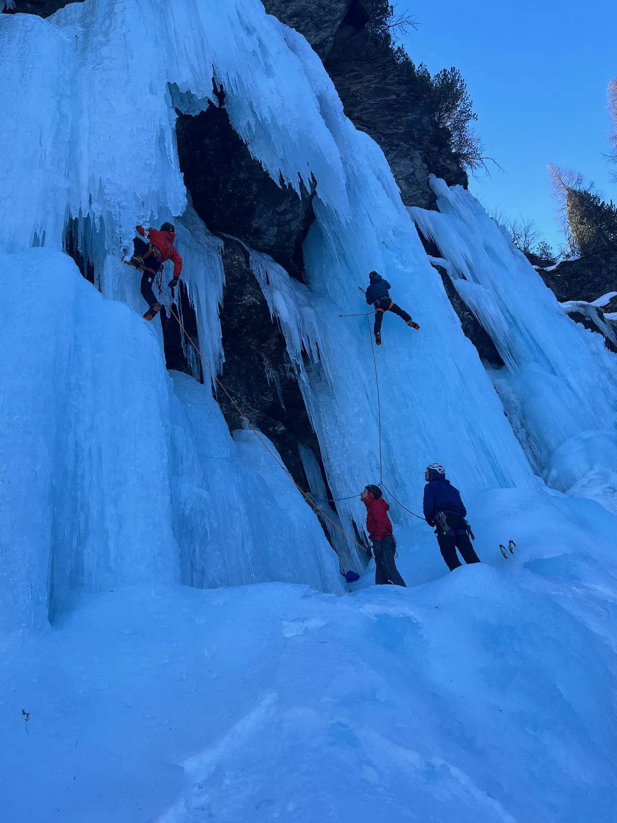 Eine Gruppe bei einem Eiskletterkurs der Innsbrucker Bergführer im senkrechten Eis